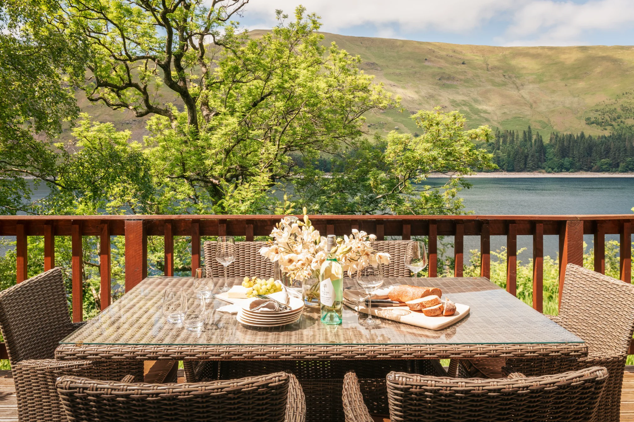 Outdoor dining area with lake and mountain views